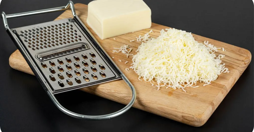 cheddar cheese with metal grater